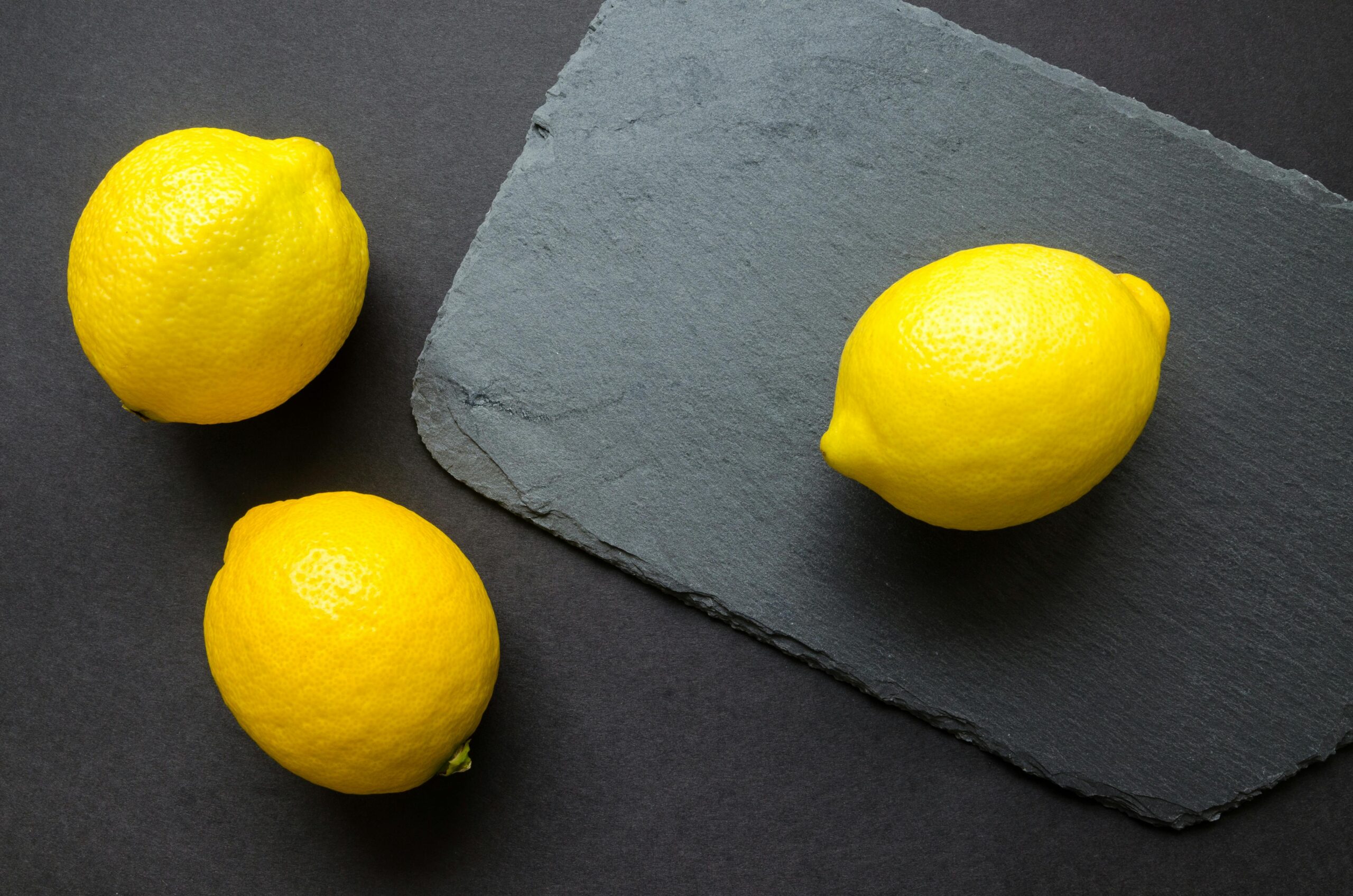 pexels photo 952360 952360 High-angle shot of vibrant lemons on dark slate, emphasizing freshness.