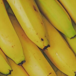 Home Vibrant and fresh close-up of yellow bananas, highlighting their ripe texture and appeal.